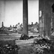 A group of children sit amongst the ruins of Charleston, South Carolina, destroyed in fighting during the American Civil War.